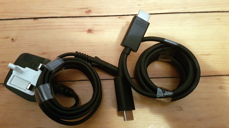 The only two cables that come with the Xbox One S: a power cord and HDMI 2.0 cable